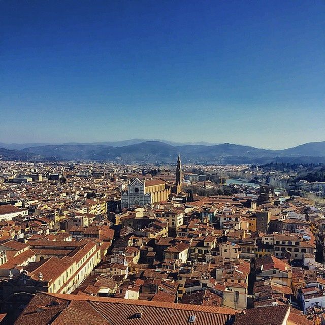 building exterior, architecture, built structure, cityscape, clear sky, city, copy space, crowded, high angle view, residential district, blue, residential structure, residential building, town, mountain, aerial view, townscape, outdoors, city life, day