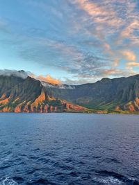 Scenic view of lake by mountains against sky