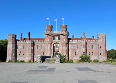 Low angle view of historical building against clear blue sky