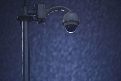 Low angle view of security camera at night