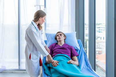 Doctor examining patient in hospital