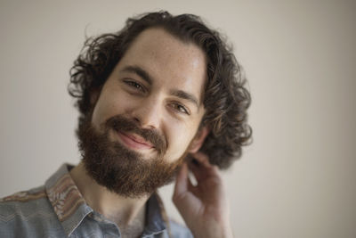 Portrait of young man against white background