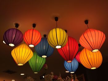 Low angle view of illuminated lanterns hanging in row