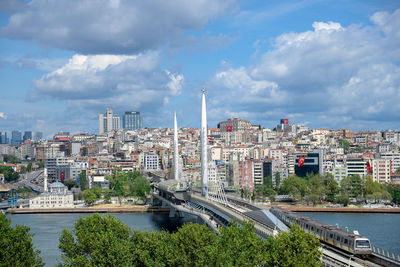 River amidst buildings in city against sky