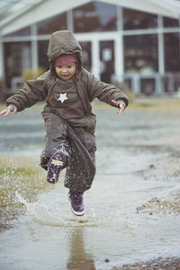 Full length of boy playing in water