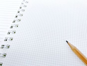 High angle view of pencil on spiral notebook