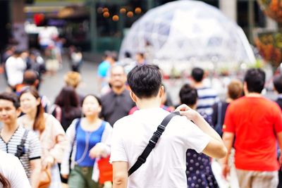 Rear view of people on street in city