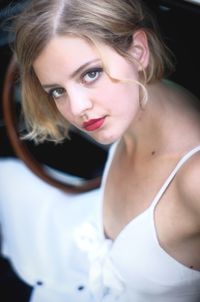 Portrait of beautiful woman wearing red lipstick and white dress