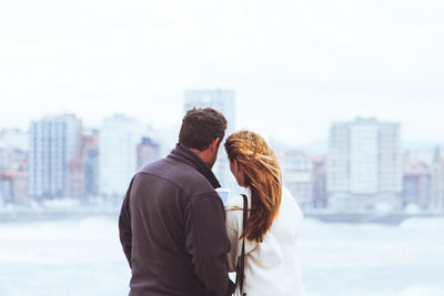 Rear view of couple standing in city