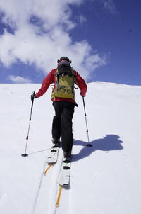 Low angle view of man walking on snow