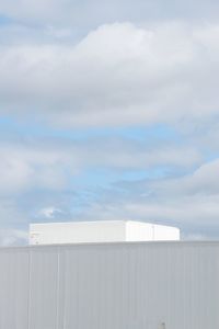 Close-up of white wall against sky