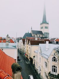 Buildings in city against clear sky