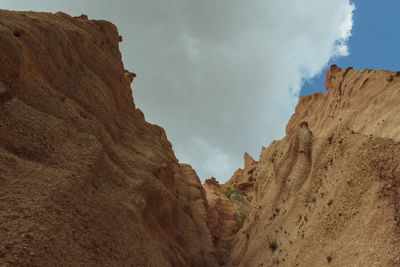 Low angle view of rock formations against sky