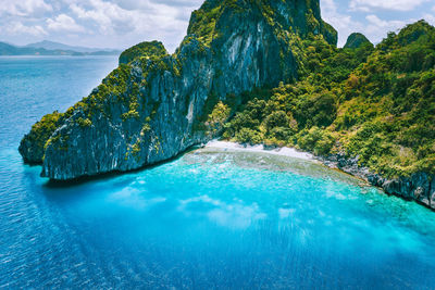 Swimming pool by sea against sky