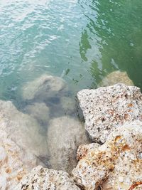 High angle view of rocks by lake