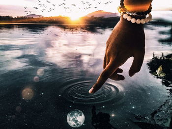 Low section of woman with reflection in water