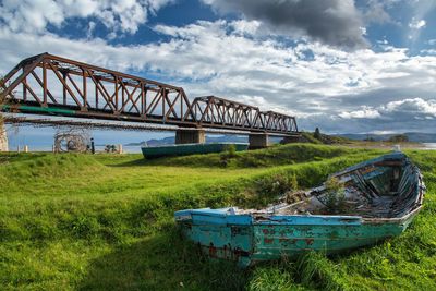 View of bridge over landscape against cloudy sky