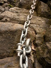 Steel bolt anchor eye in hard basalt rock. climbers path via ferrata. iron chain fixed in block.