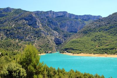 Scenic view of sea and mountains against sky