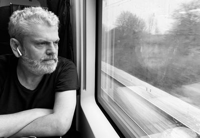 Man looking through train window