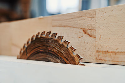 Wood cutting machine blade. circular saw. wooden bar in carpentry workshop. woodworking industry.