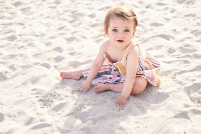 Portrait of cute girl playing at sandy beach