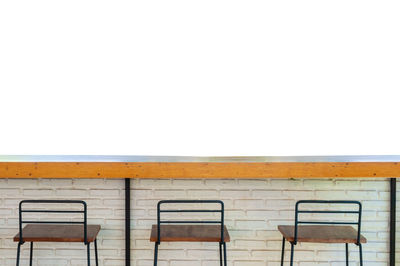 Empty bench against clear sky