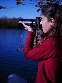 Woman photographing at camera