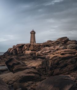 Rock formation by building against sky