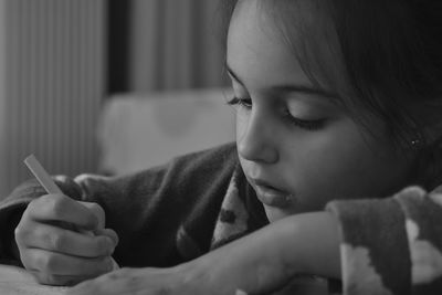 Close-up of girl studying at home