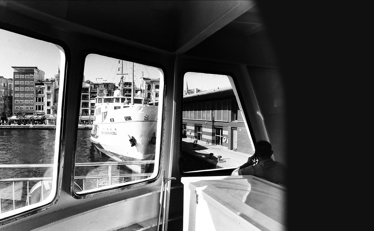 VIEW OF TRAIN SEEN THROUGH WINDOW OF BUILDING