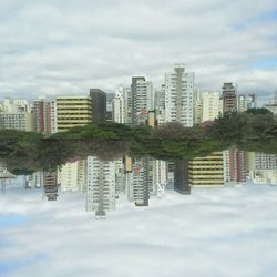 Buildings against cloudy sky