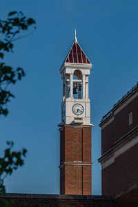 Full frame view of clock and bell tower on purdue university campus with clear blue sky