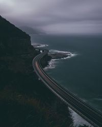 High angle view of road by sea against sky