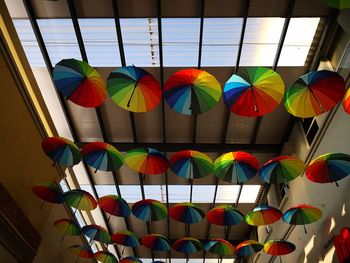 Low angel view of colorful umbrella hanging on roof