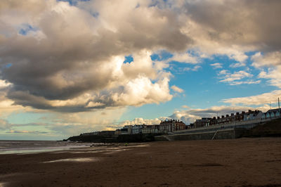 Scenic view of beach against sky in city