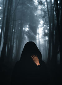 Man in forest against trees