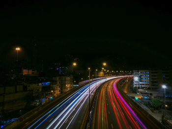 High angle view of light trails on highway at night