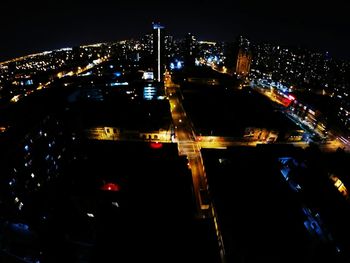 Illuminated cityscape against sky at night