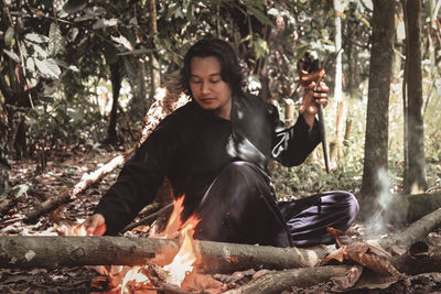 Young man sitting in park