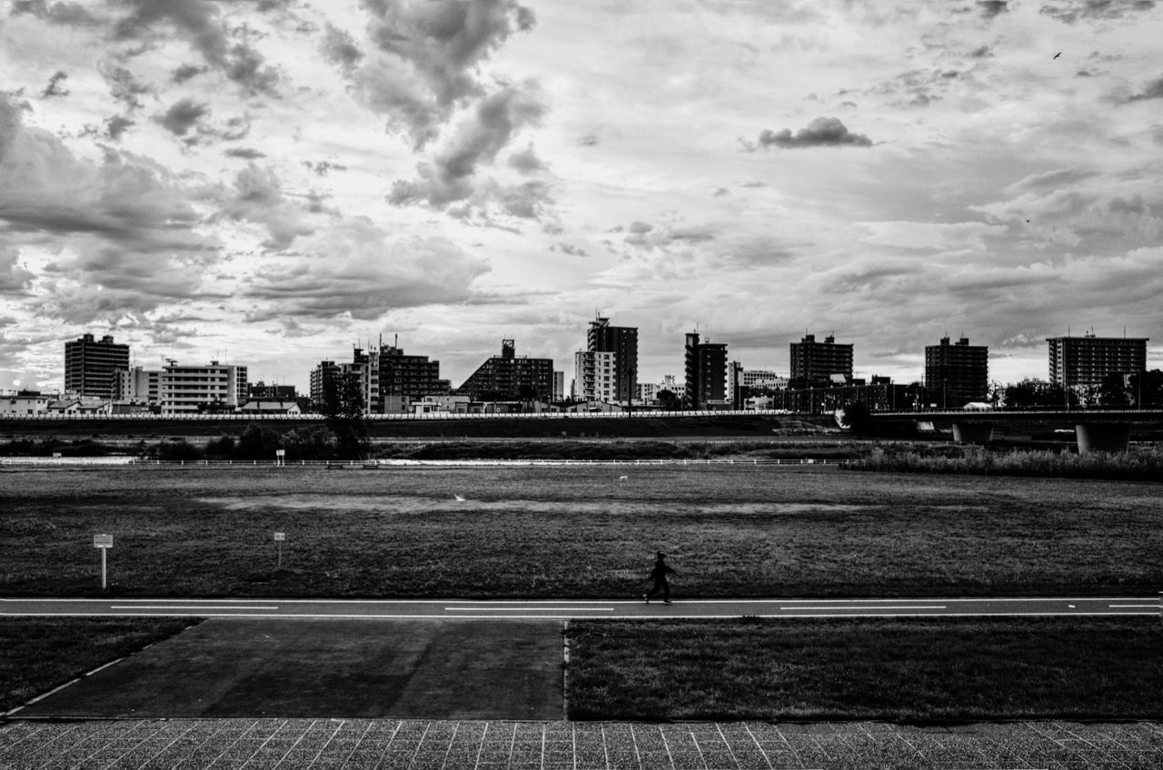 architecture, building exterior, sky, city, built structure, cloud - sky, day, outdoors, one person, skyscraper, real people, cityscape, men, urban skyline, nature, one man only, people