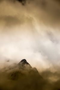 Low angle view of volcanic mountain against sky