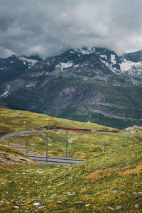 Railway and red train in gornergrat mountains. zermatt, swiss alps. adventure in switzerland.