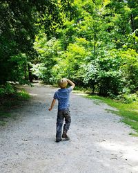 Full length rear view of a girl standing on road