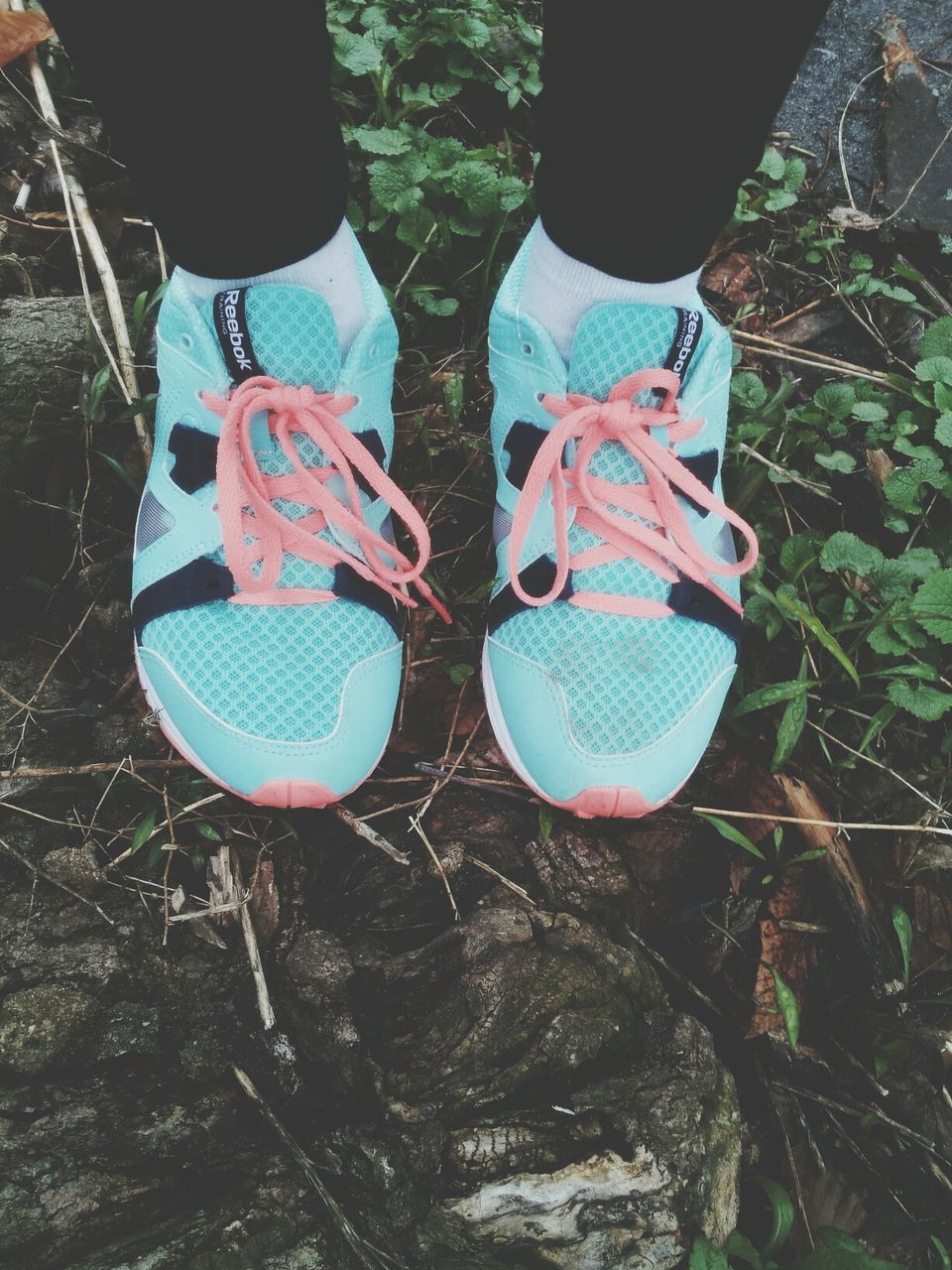 shoe, low section, lifestyles, leisure activity, standing, high angle view, person, childhood, footwear, outdoors, day, men, sport, canvas shoe, close-up, field, hanging, casual clothing