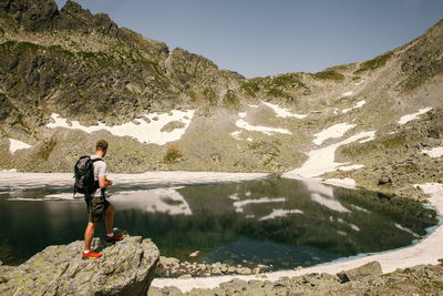 Man standing on rocks against mountain