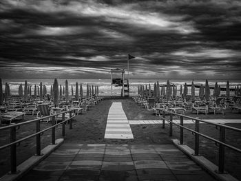 Pier over sea against sky in city