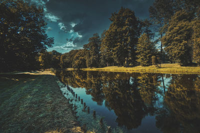 Scenic view of lake in forest against sky