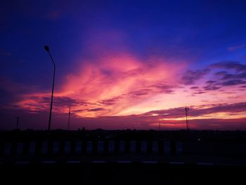 Silhouette landscape against orange sky