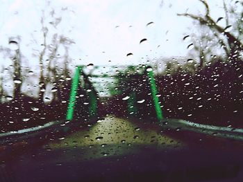 Road seen through wet car windshield